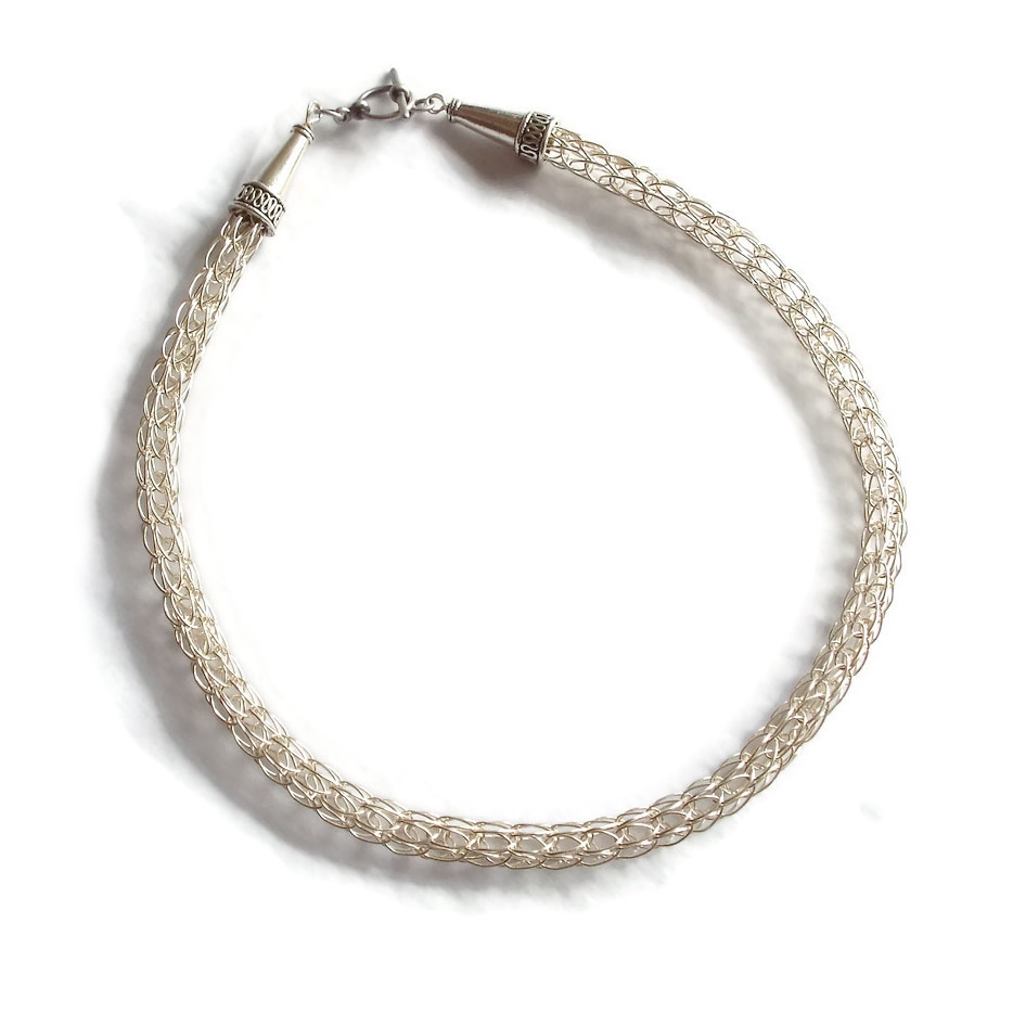 A hand-made Viking Knit necklace in silver-coloured copper wire.
